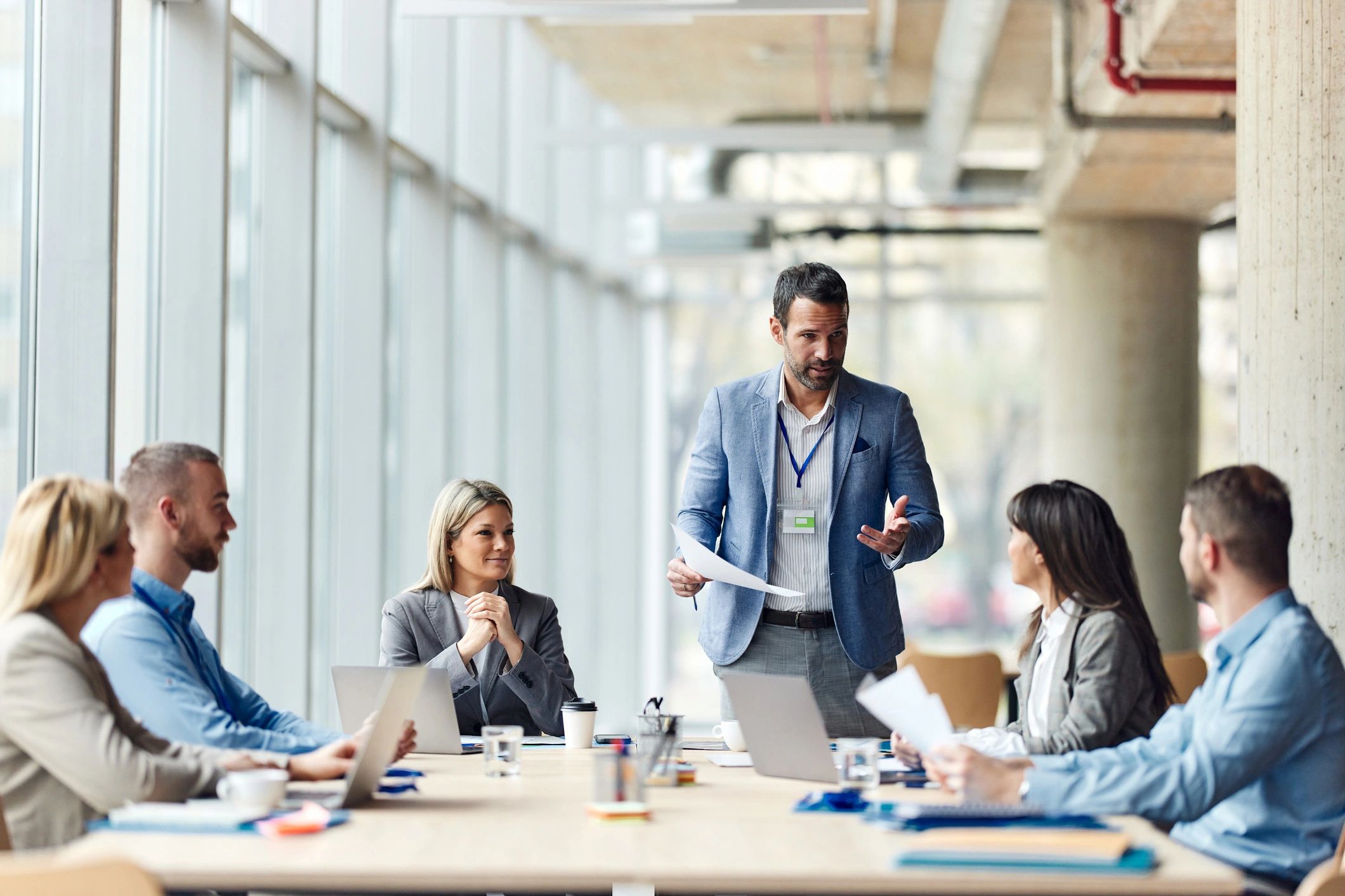 Leader facilitating a team discussion in a modern office.