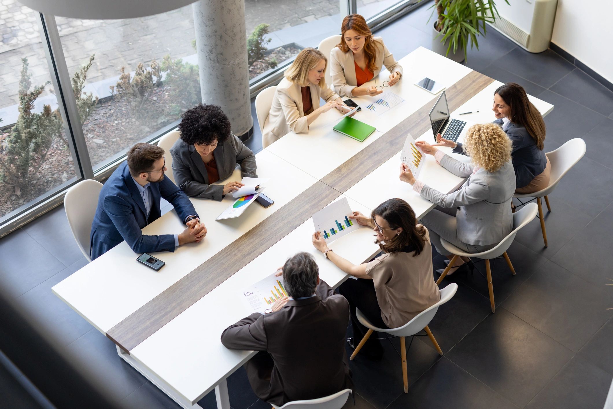 Corporate strategy workshop with a diverse team collaborating around a table