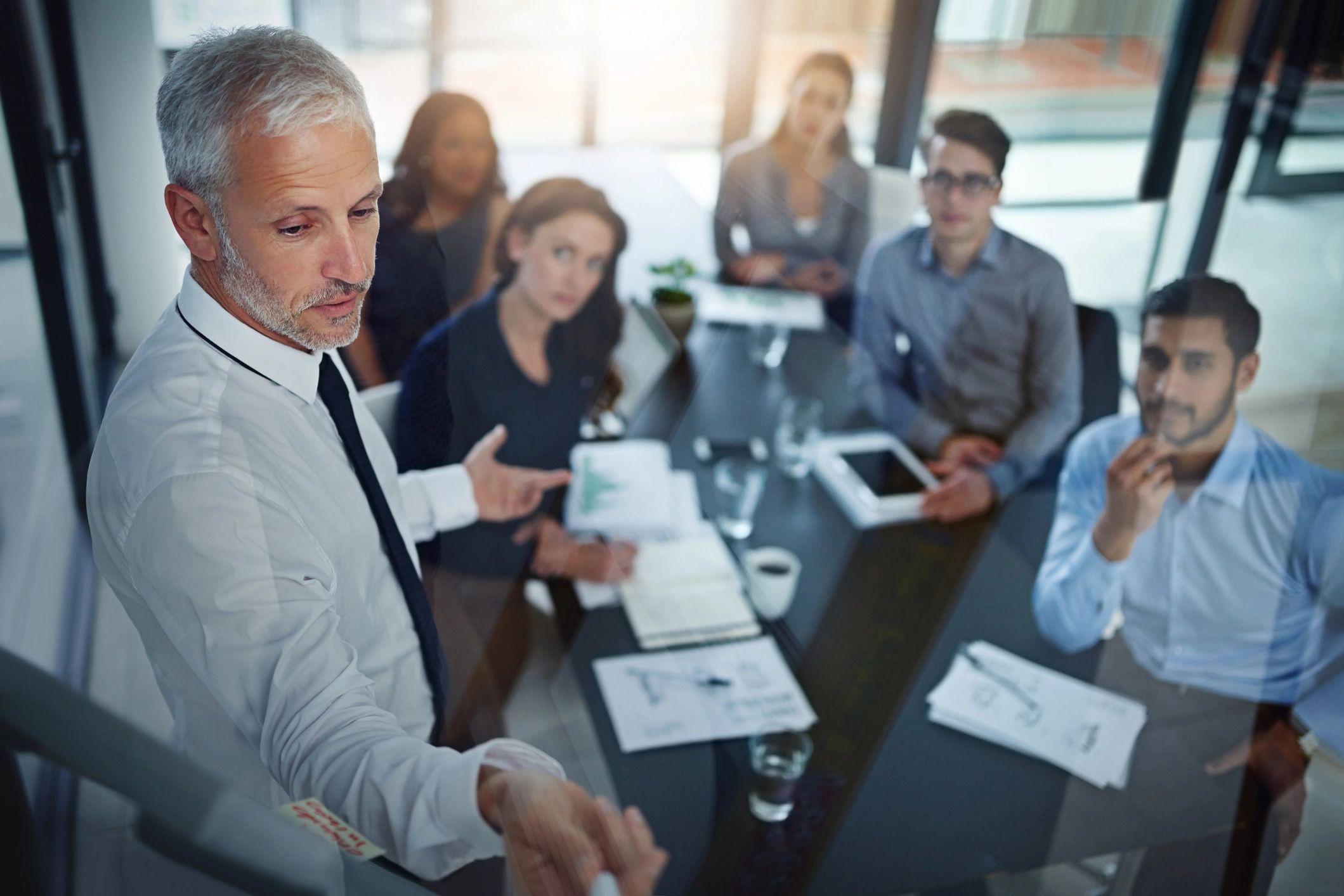 Executive team listening to a presentation in a boardroom